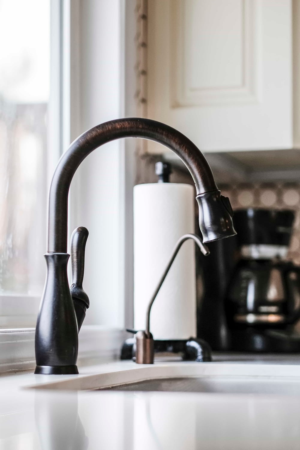 Oil rubbed bronze goose neck faucet installed over a farmhosue undermount sink