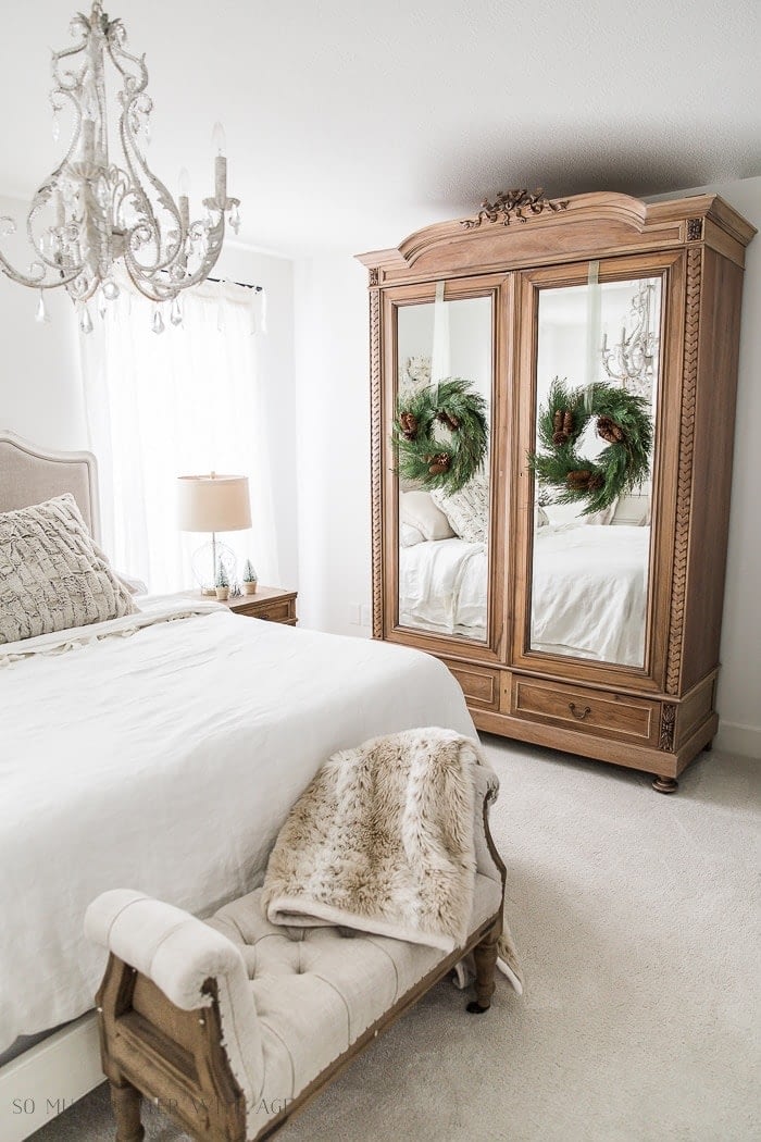 minimalist christmas decorations using two wreaths hung on an armoire