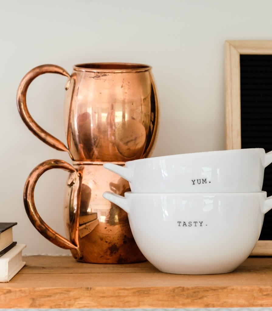 copper mugs and soup bowls on a shelf as fall decor