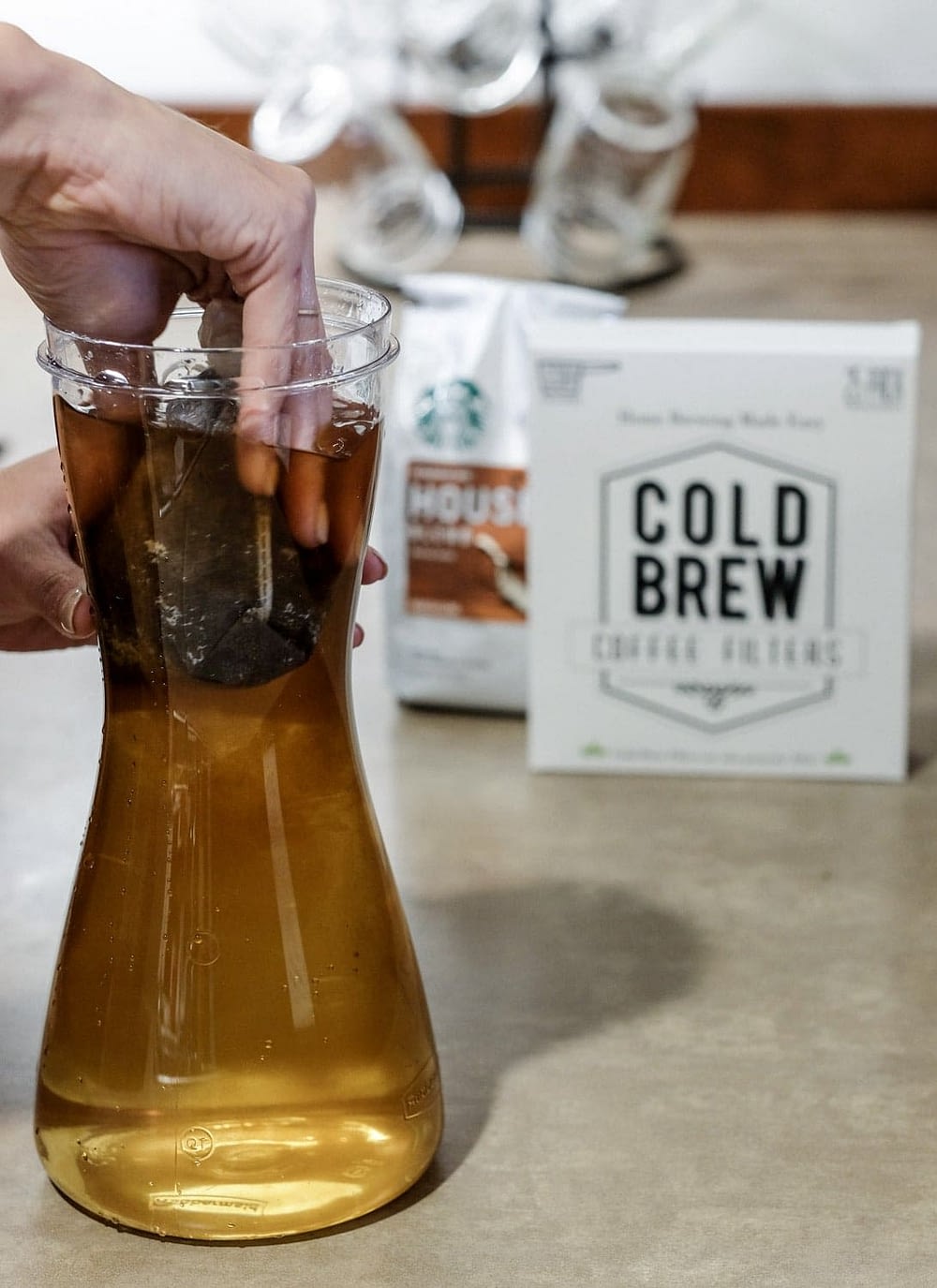 putting cold brew coffee grinds into water