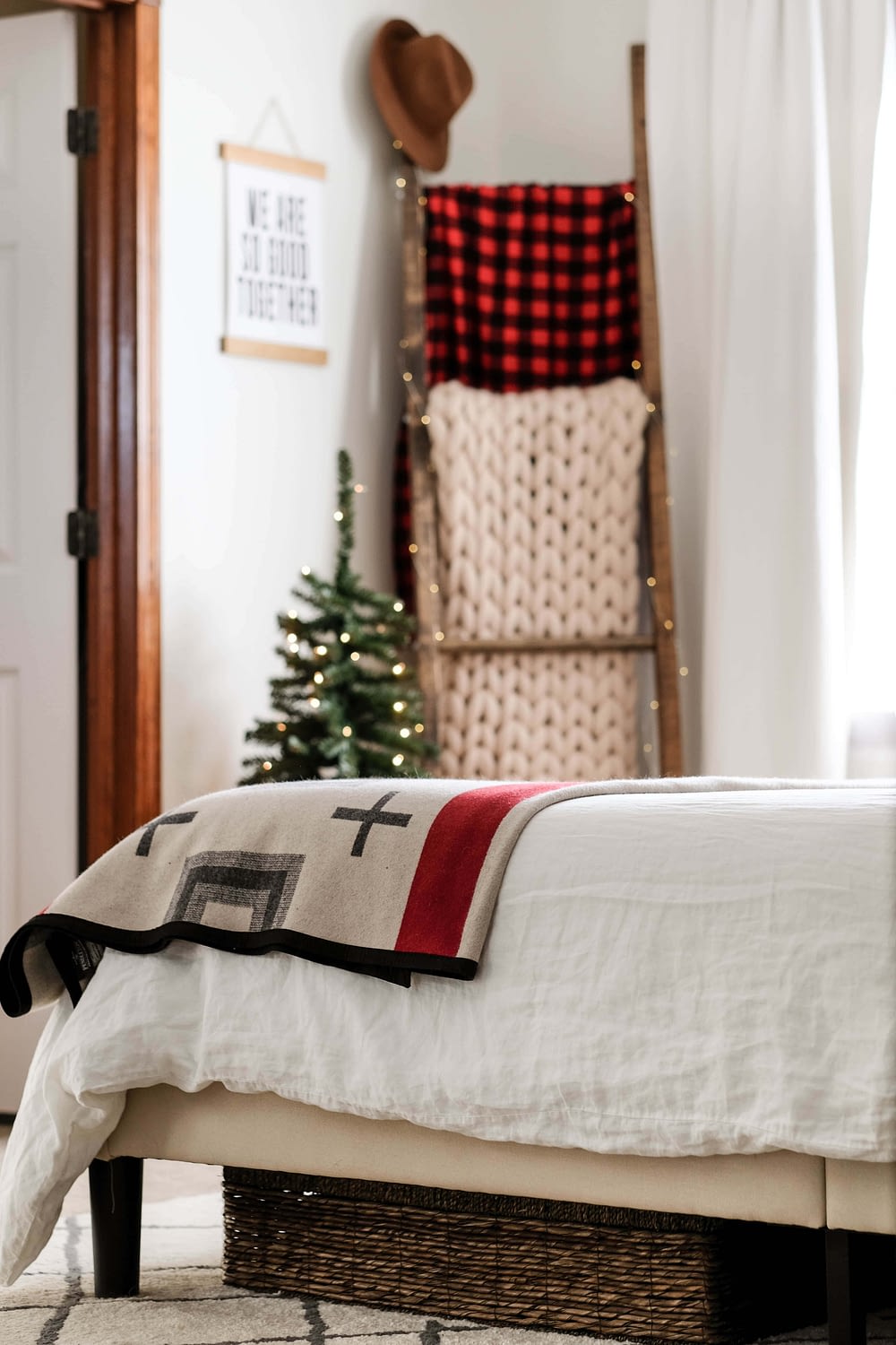 Christmas bedroom decor ideas with a blanket ladder and mini christmas tree