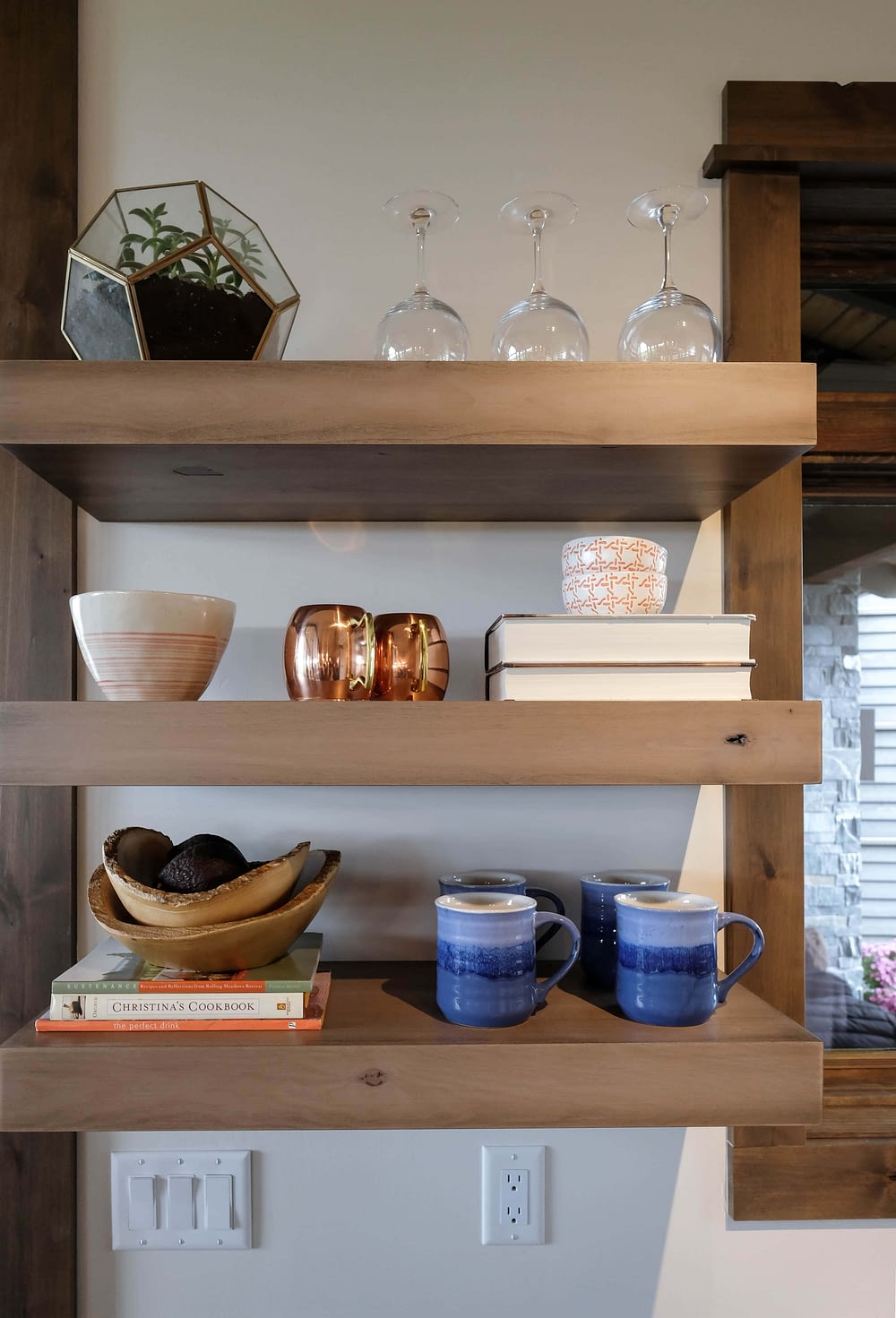 Parade of Homes styled shelf with cups, books, and other decor