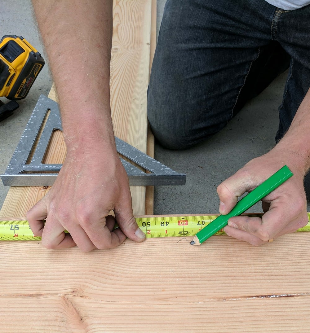 An overhead view of measuring and marking lumber