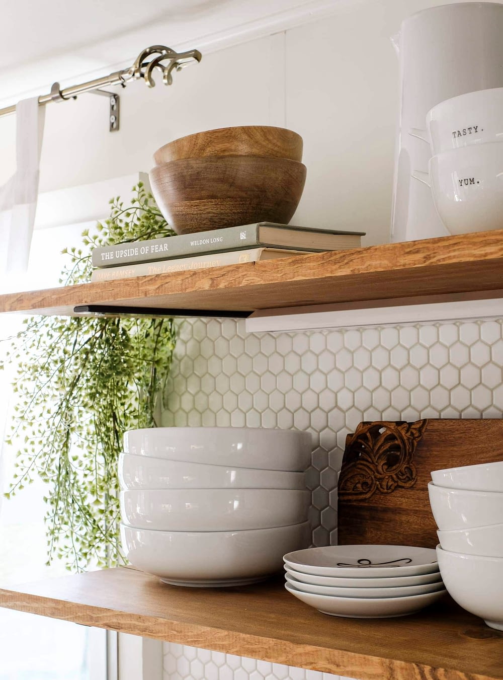 Open shelving with stacked bowls and cascading greenery