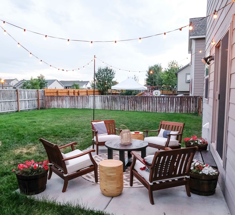 outdoor patio makeover with string lights and lots of seating
