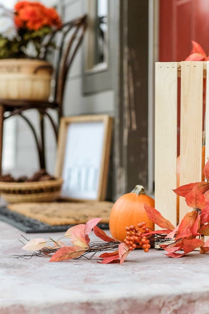 fall front porch decorated with pumpkins and other decor 