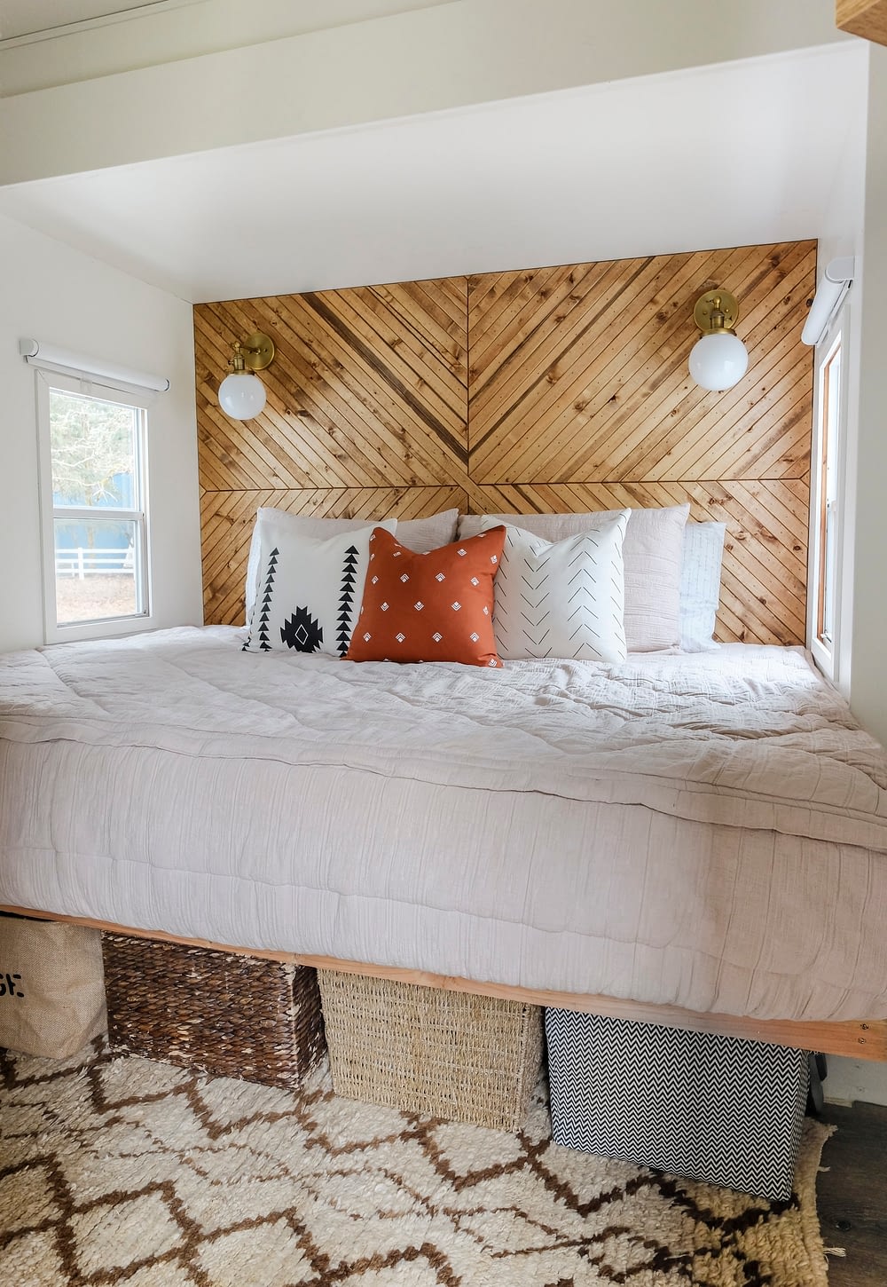 RV bedroom remodel with underbed storage and a geometric wood plank accent wall