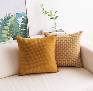 textured mustard yellow throw pillows set of 2 styled in a coastal style decor setting