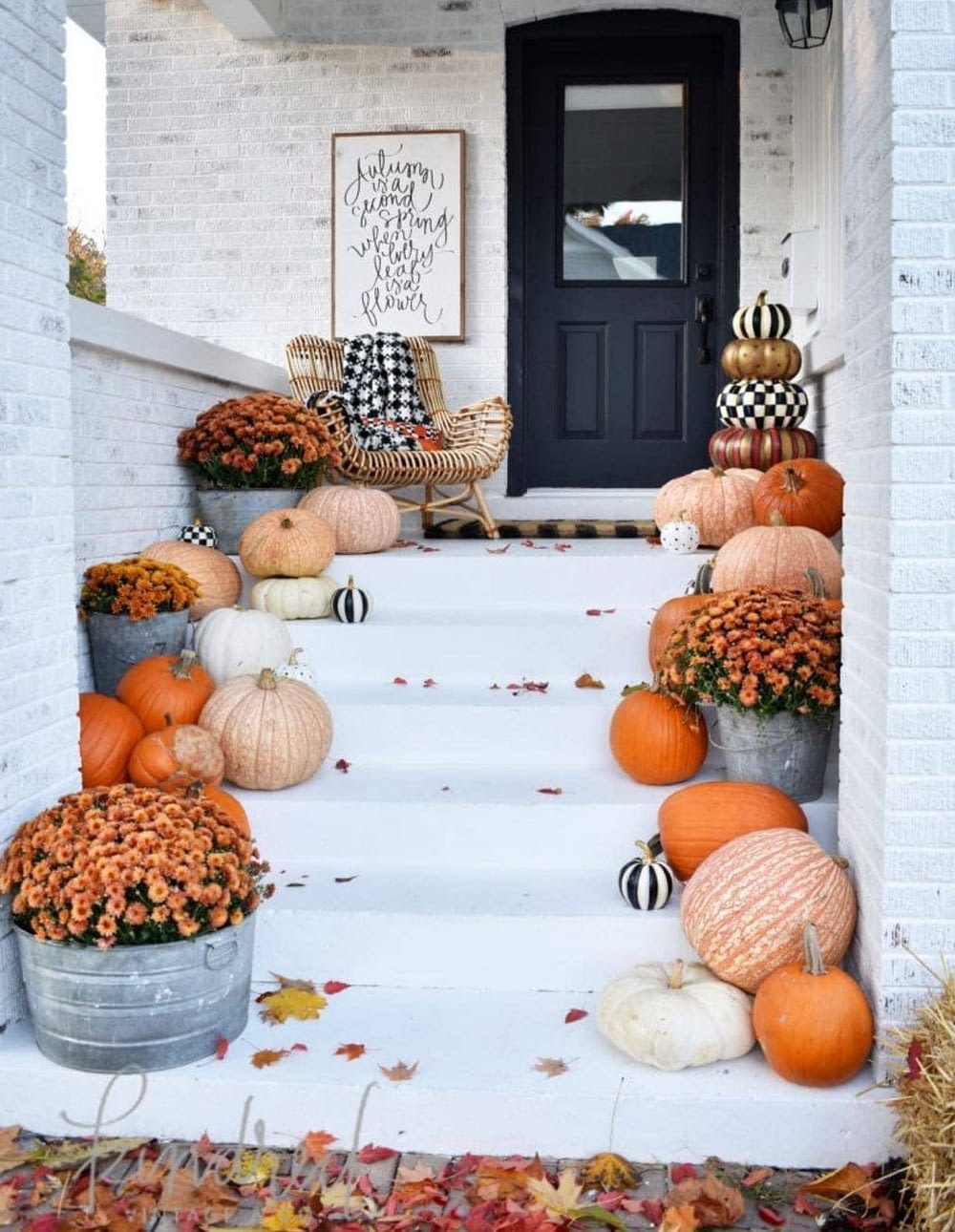 Fall front porch ideas using tons of pumpkins on each step leading to the front door