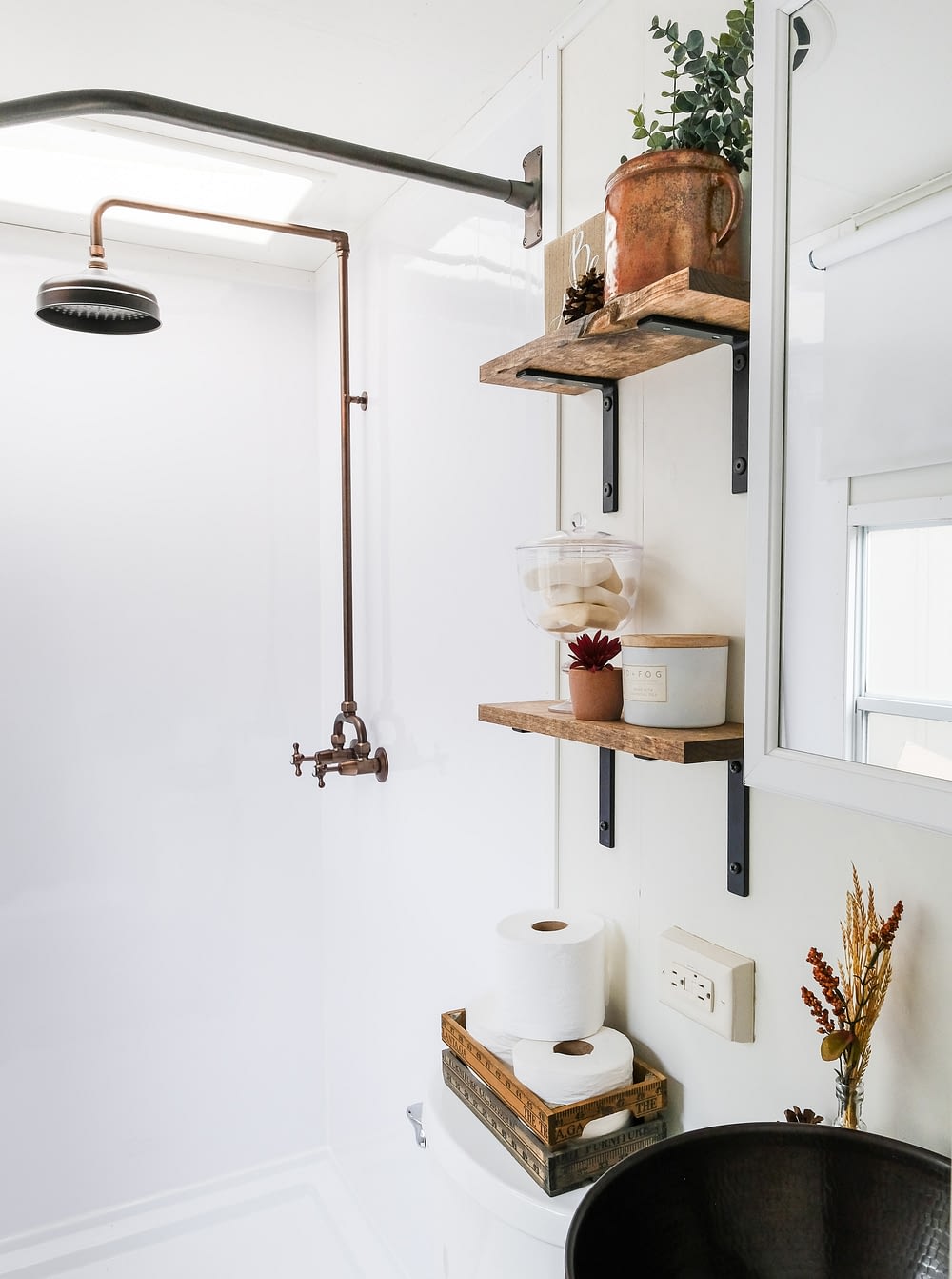 RV bathroom remodel with copper fixtures and open shelving