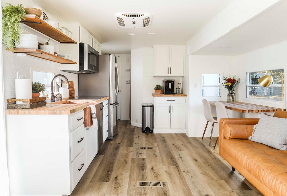 RV kitchen remodel with white cabinets and wood look flooring