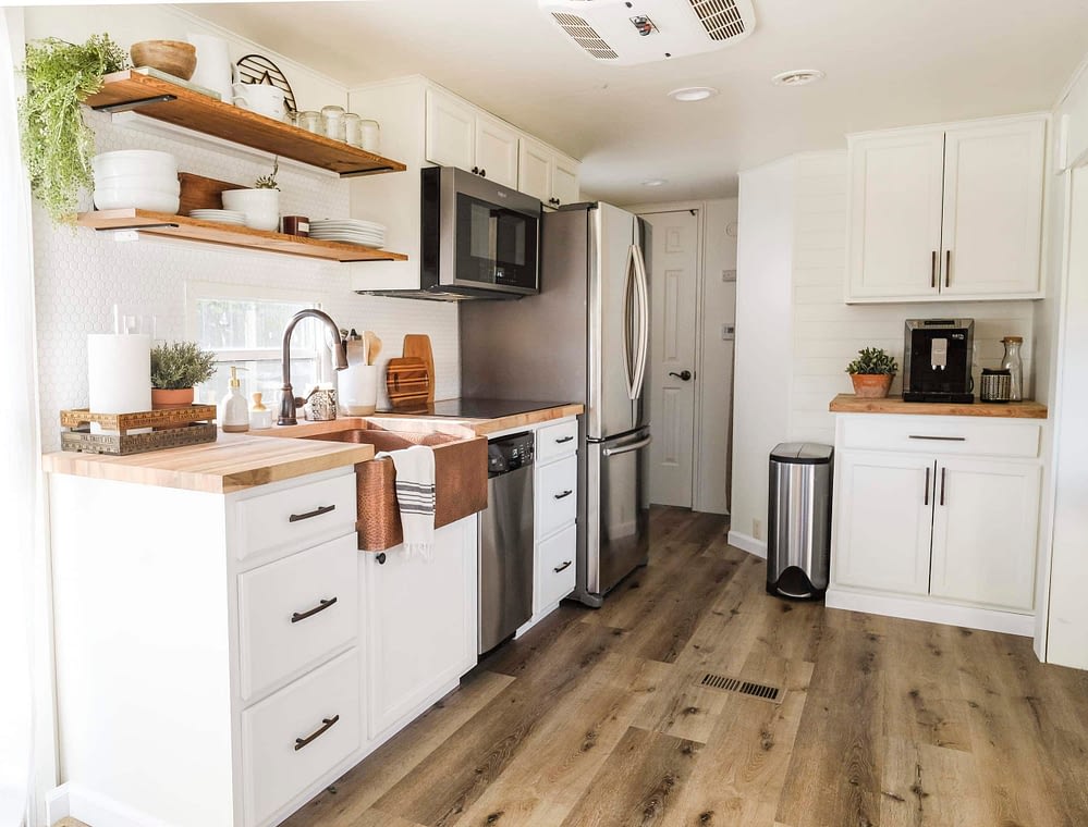 RV kitchen remodel with white cabinets wood look flooring and open shelves
