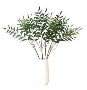 artificial eucalyptus branches inside a white vase