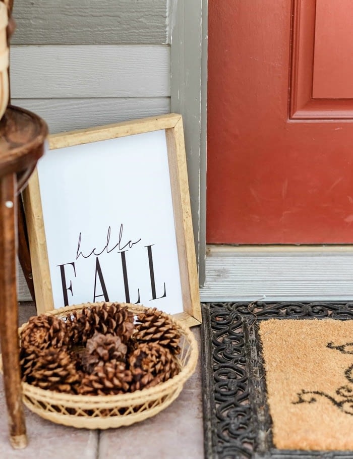 small front porch decorated for fall with a framed free printable 