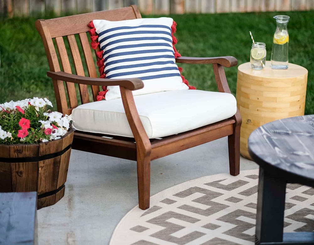 outdoor patio makeover with wood chairs and throw pillows