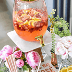 Summer bar cart with strawberry lemonade sangria in drink dispenser