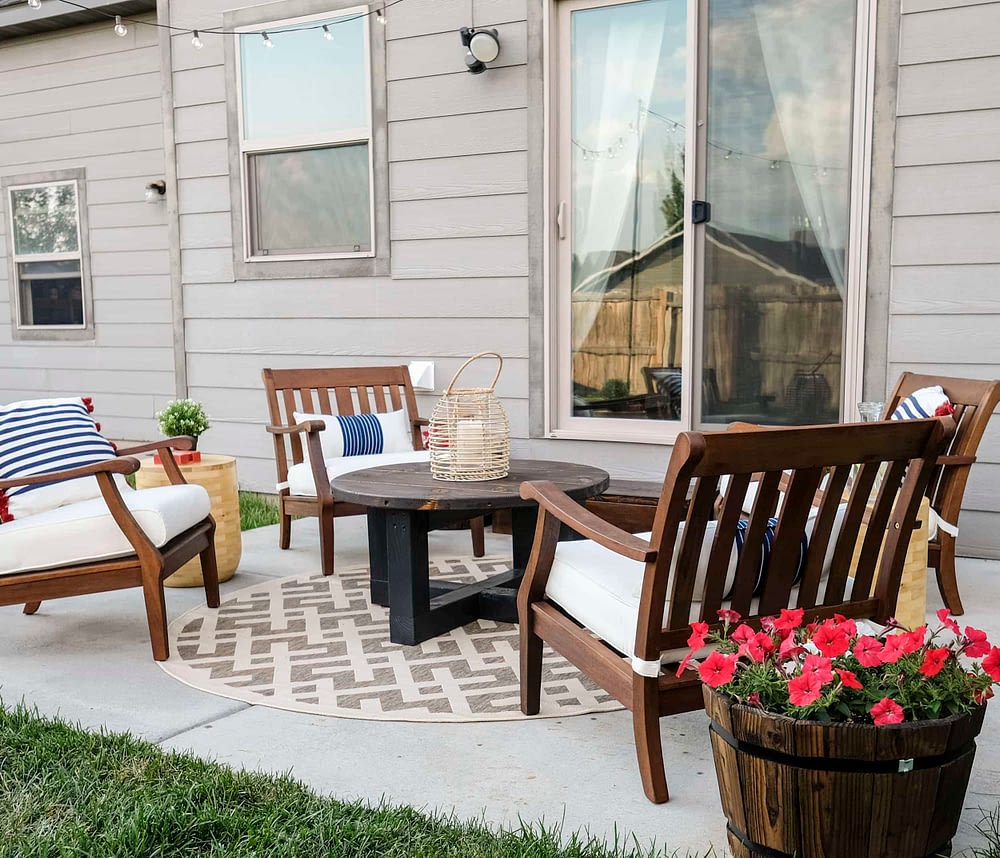 patio makeover with four chairs around a rustic coffee table