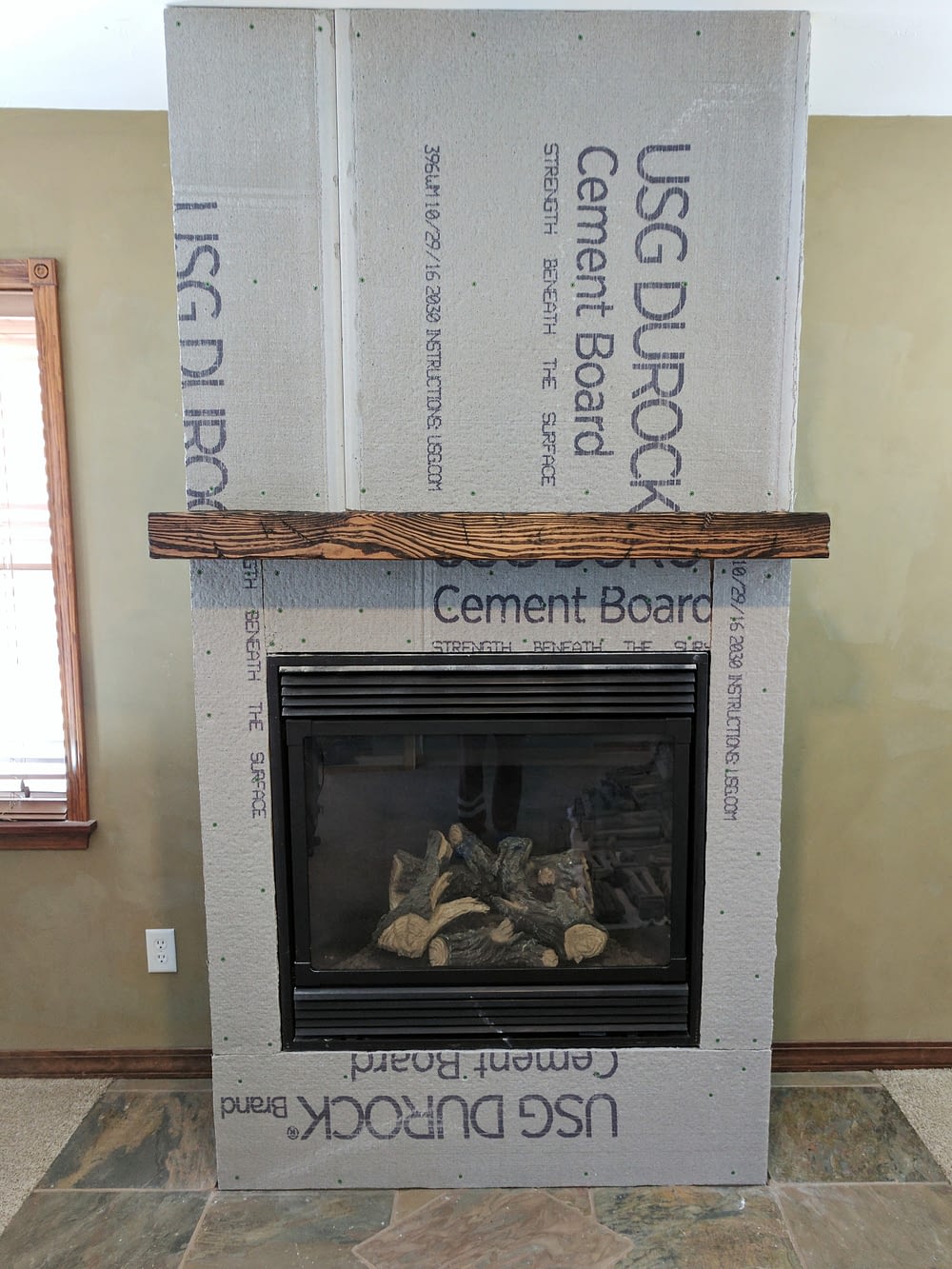 Fireplace remodel with durock cement board and mantel installed