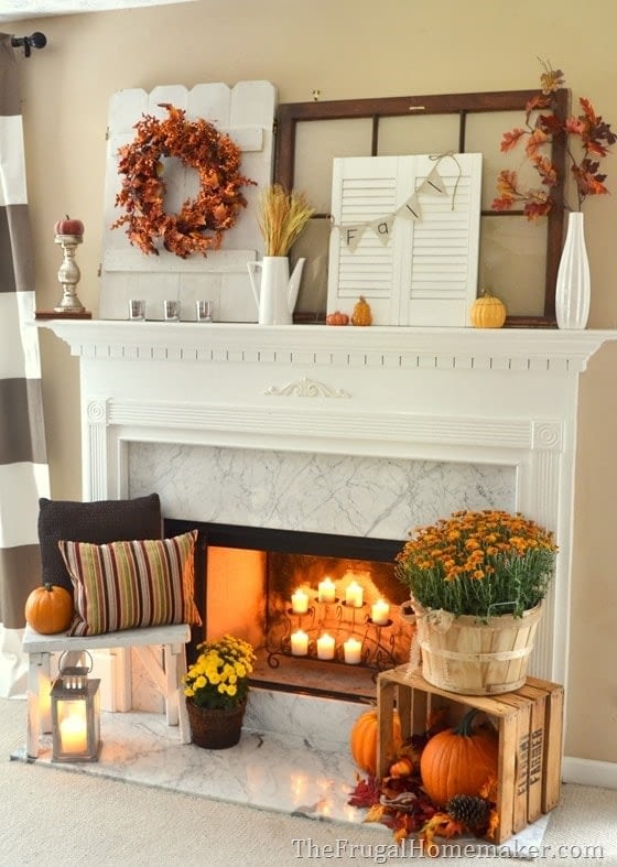Fall mantel ideas with candles inside the fireplace