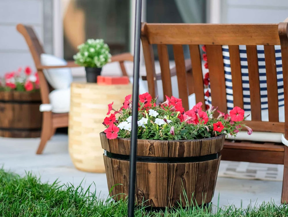 outdoor patio with small whiskey barrels used as flower pots