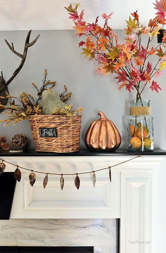 Fall mantel ideas using copper pumpkins, tree clippings and a leaf banner
