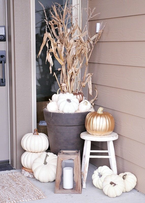 Fall front porch ideas using white pumpkins and corn stalks