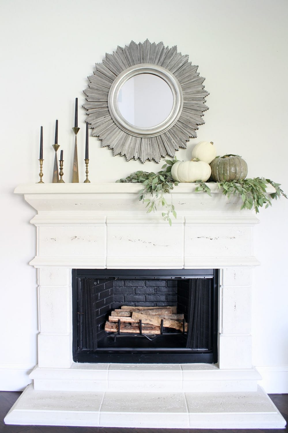 Fall mantel ideas for a minimal look using candles, pumpkins, and a mirror