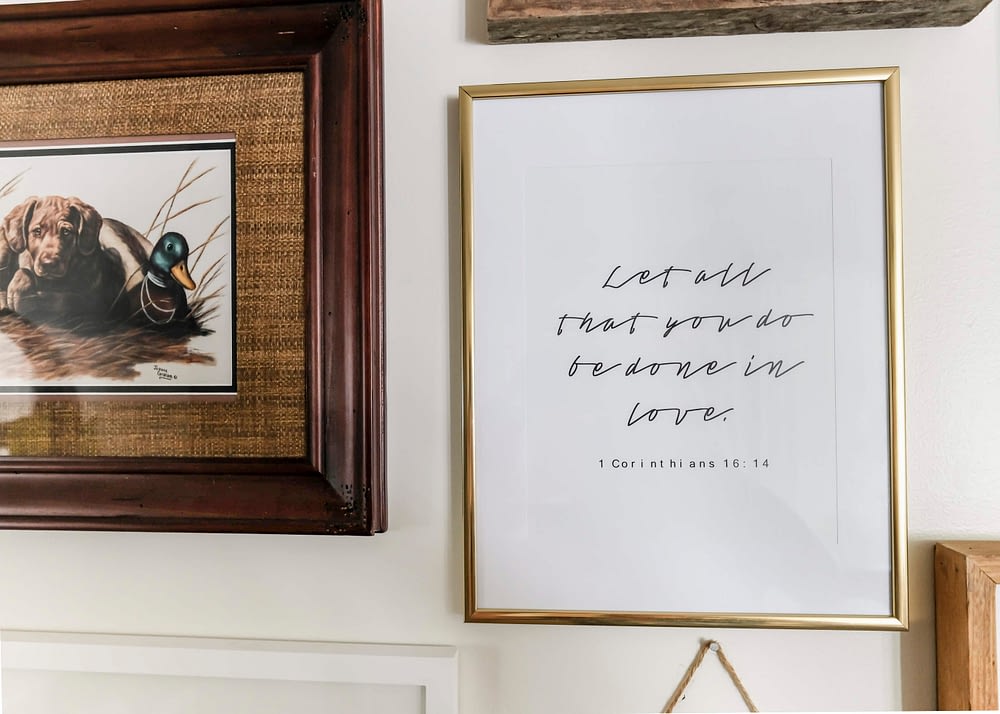 gallery wall with printable that reads "let all that you do be done in love"