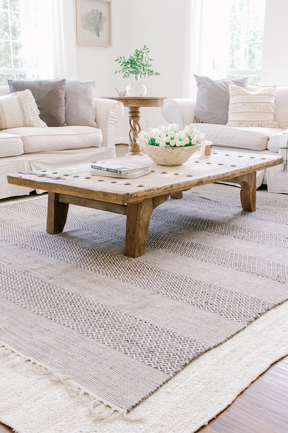 living room with layered rugs