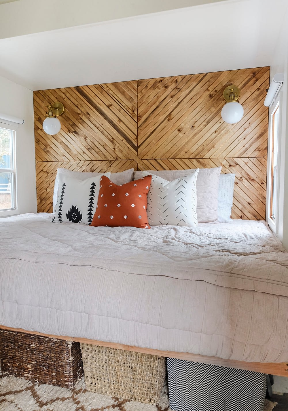 A small bedroom with a wood accent wall