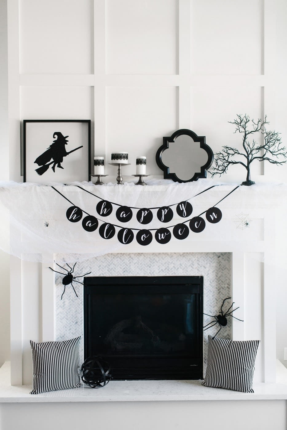 Fall mantel ideas for a halloween mantel using black and white decor and fake spiders