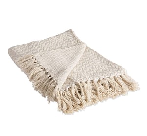 off white cotton throw blanket with subtle pattern and fringe detail