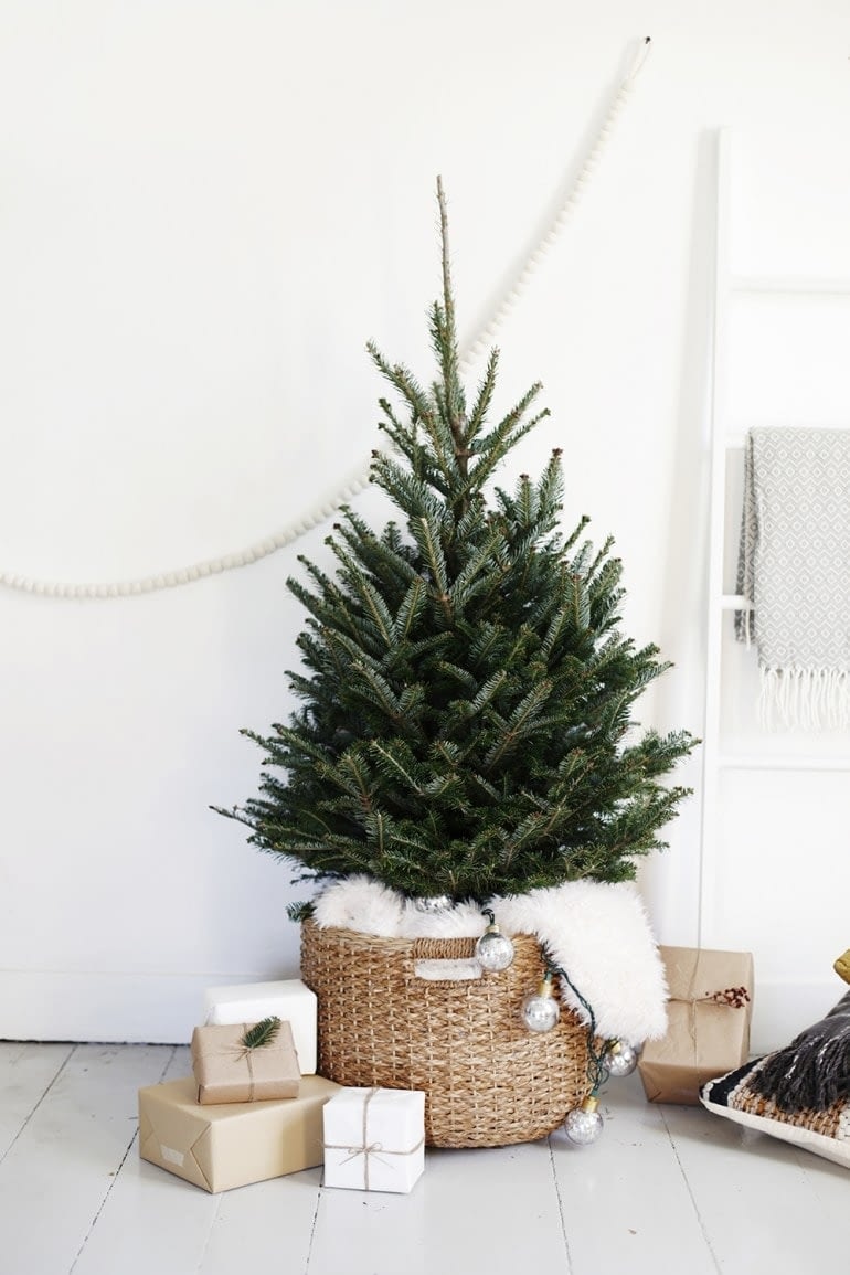 minimalist christmas tree with no ornaments in a woven basket