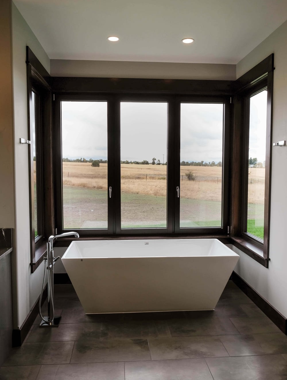 Parade of Homes bathroom with large tub surrounded by windows