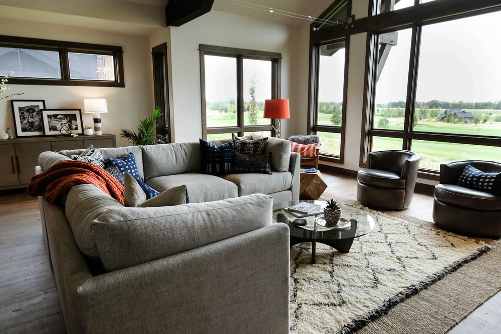 Parade of Homes living room with couch, chairs, and rug 