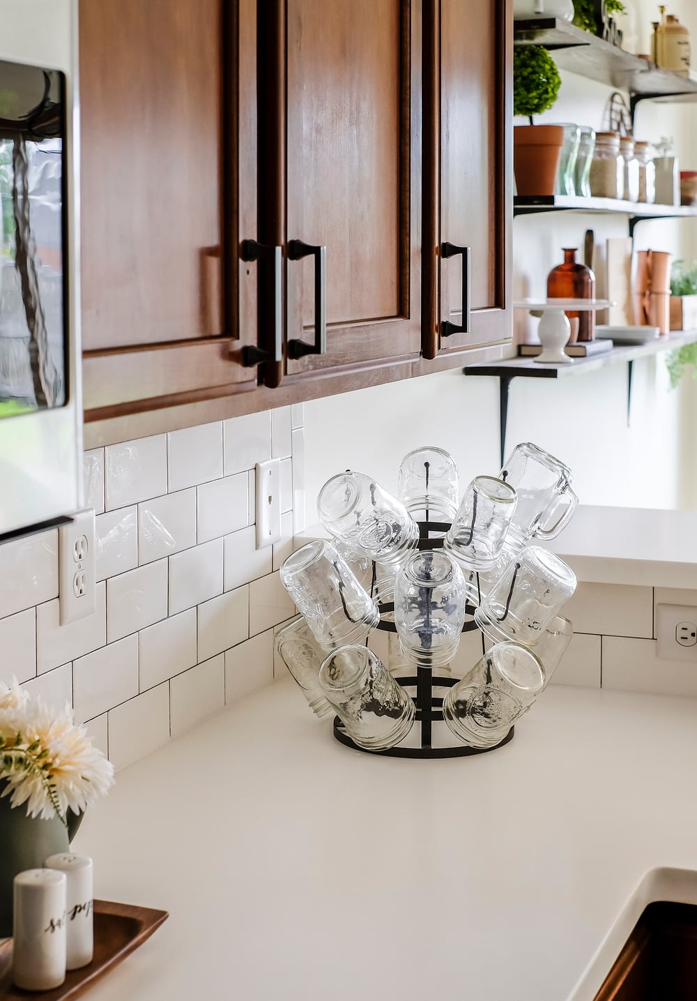 white solid surface countertops with mason jar glasses on a cup holder