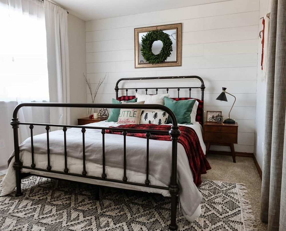 Christmas bedroom decor ideas including a farmhouse bed with a wreath above it